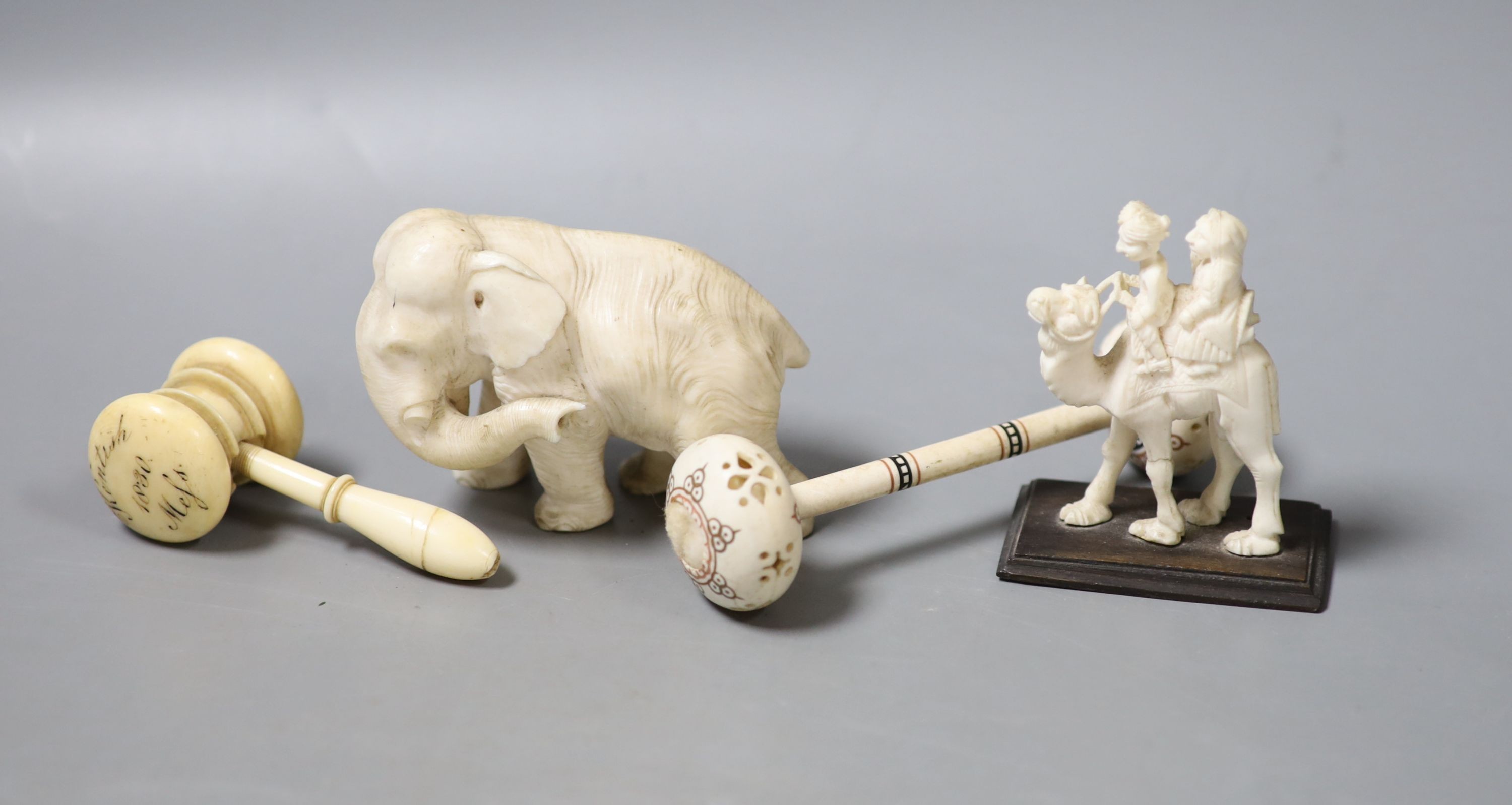 A Japanese Ivory okimono of an elephant, signed, an ivory gavel (incomplete) and two other Ivory carvings, 19th/early 20th century